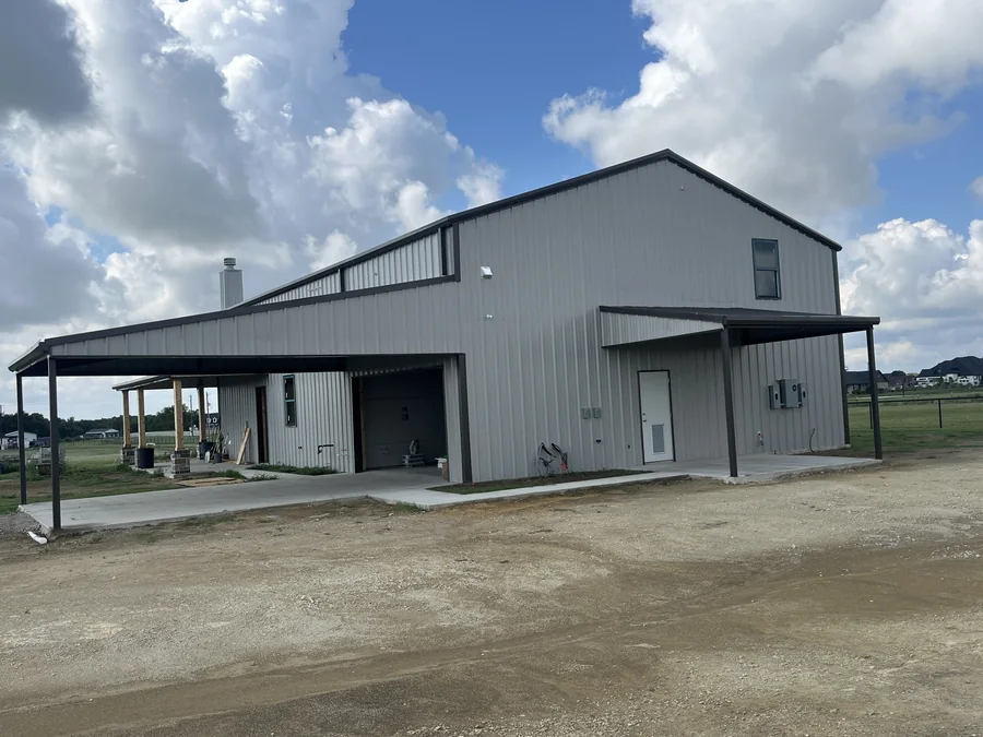 Finished metal workshop building with covered entry